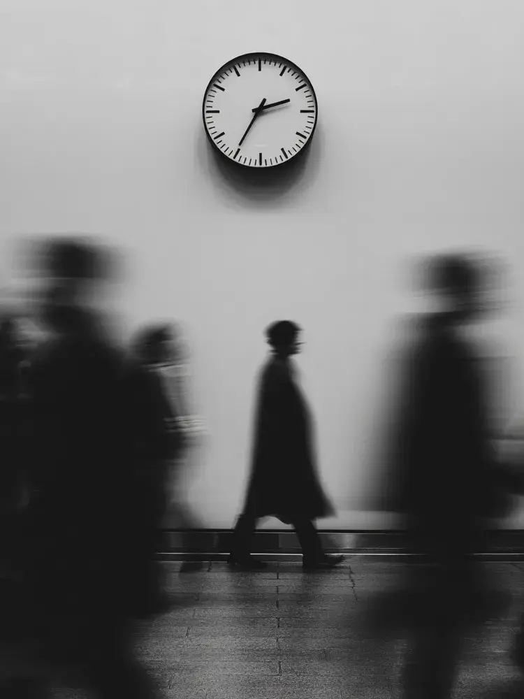 Flat lay of printed photographs and postcards on a wooden table.