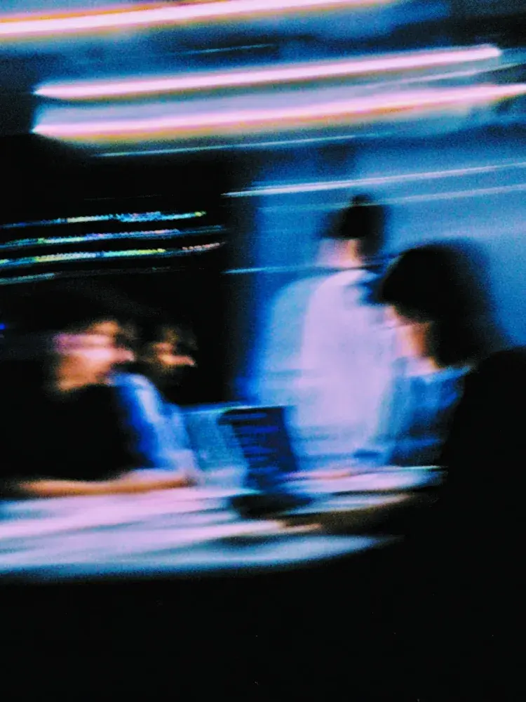 Stylish blue sneaker displayed on a neutral surface.