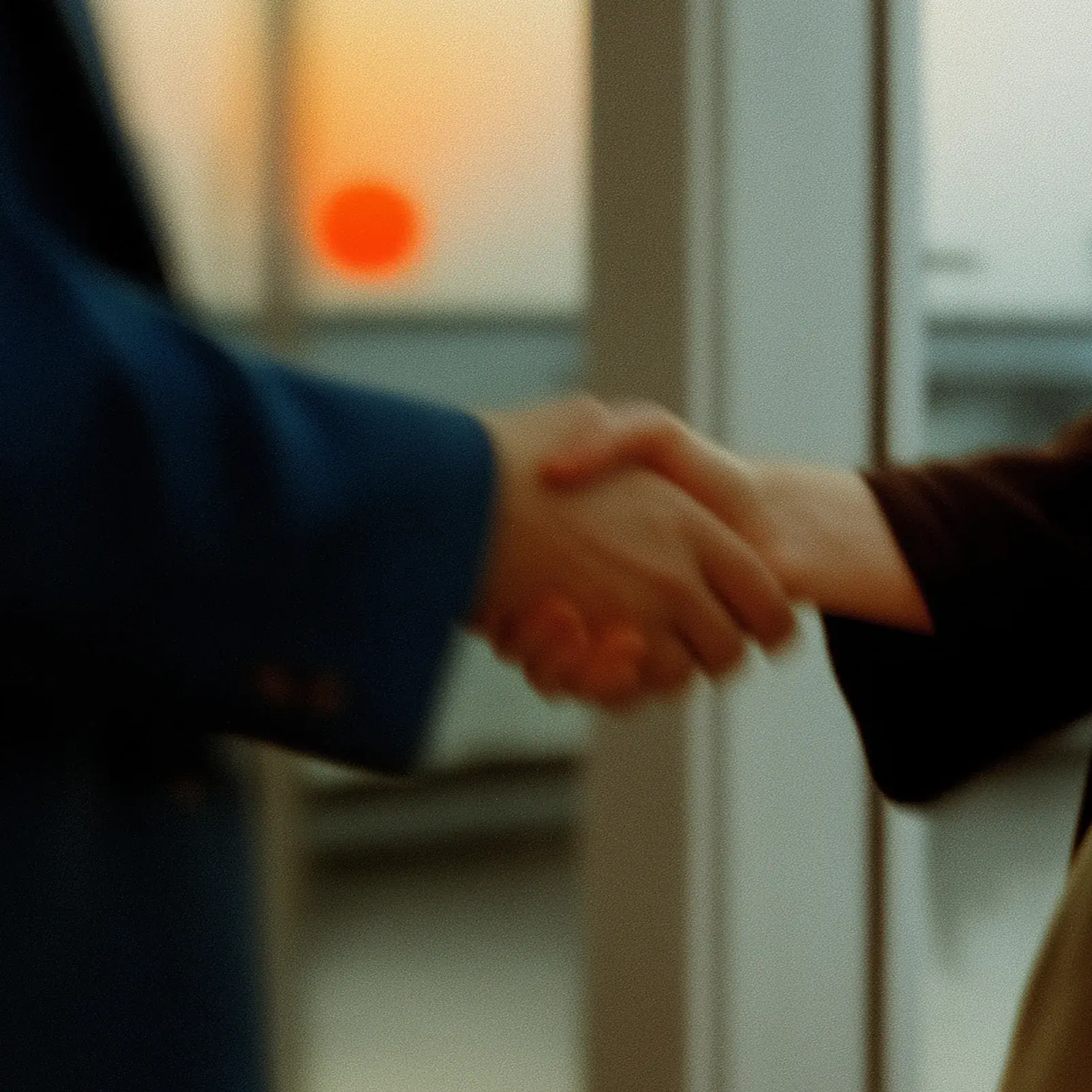 Two figures in motion blur standing against a muted green background.